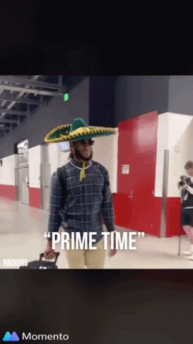 Man in Sombrero and Sunglasses Carrying Suitcase Saying Prime Time
