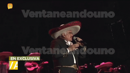 Man in Sombrero Singing Into Microphone