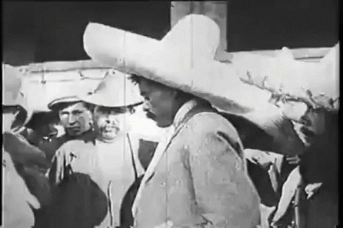 Man in Sombrero Standing in Front of Group