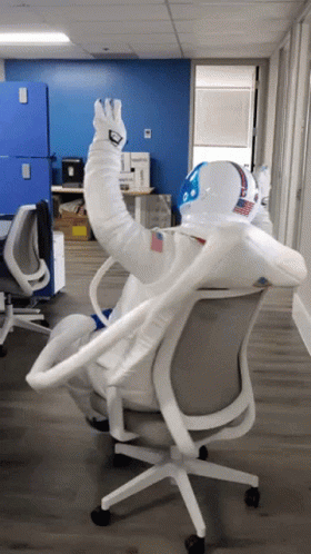 Man in Space Suit Sitting in Chair