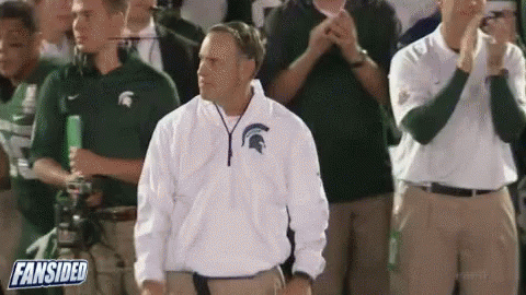 Man in Spartan Jacket Standing Before Crowd