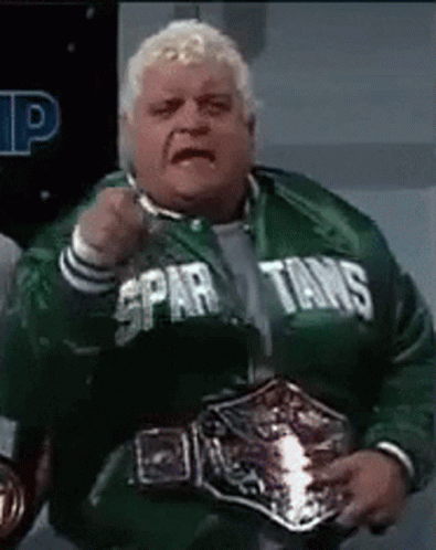 Man in Spartans Jacket Holding Wrestling Belt