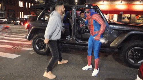 Man in Spiderman Costume Beside Jeep