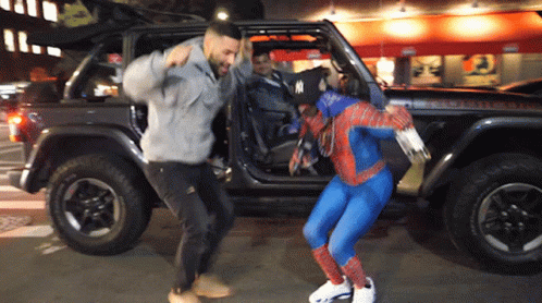 Man in Spiderman Costume Next to Jeep