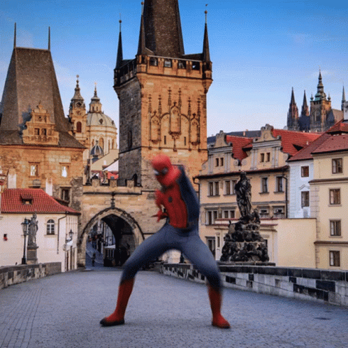 Man in Spiderman Costume on Bridge Near Castle