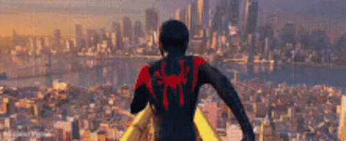 Man In Spiderman Suit Standing In Front Of City GIF