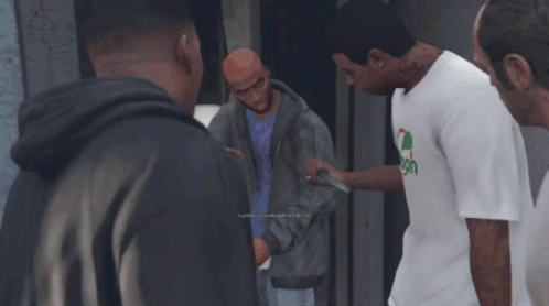 Man in Spoon Shirt Talks to Group of Men