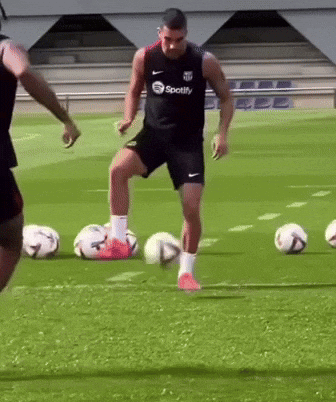 Man in Spotify Shirt Kicking Soccer Ball