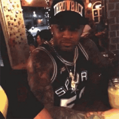 Man in Spurs Jersey and Throwback Hat