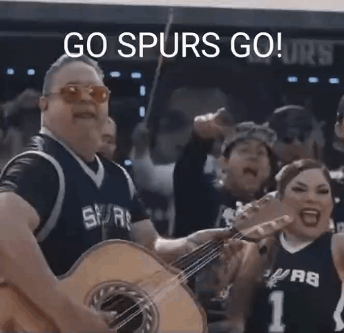 Man in Spurs Jersey Playing Guitar