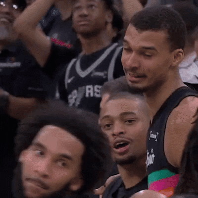 Man in Spurs Jersey Sitting in Crowd