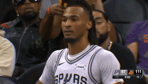 Man in Spurs Jersey Sitting in Stands