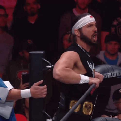 Man in Star Headband Holding Evolution Boxing Glove