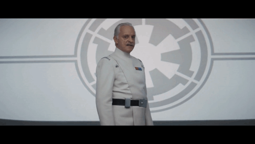 Man in Star Wars Uniform in Front of Logo
