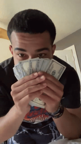 Man in Starting Shirt Holding Money