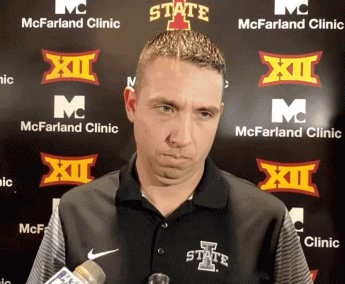 Man In State Shirt In Front Of McFarland Clinic Sign GIF