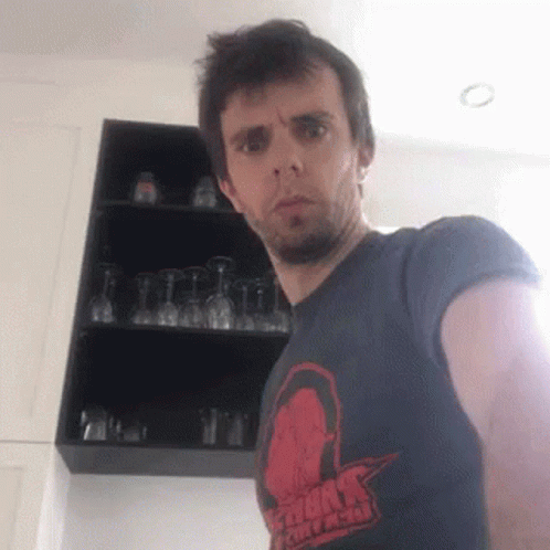 Man in Storm Chasers T-Shirt by Wine Glasses