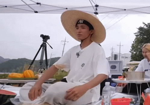 Man In Straw Hat And NY Hat Sitting GIF