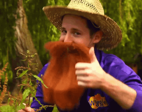 Man in Straw Hat and Purple Shirt Wiggles