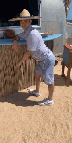 Man in Straw Hat and Shorts on Beach