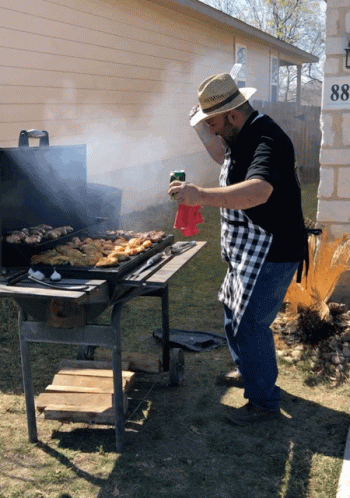 Man in Straw Hat Grilling Outdoors