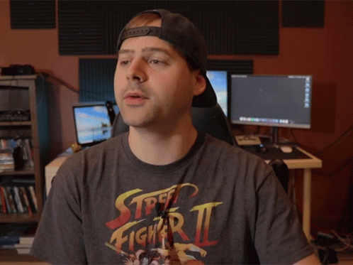Man in Street Fighter Zero Shirt Holding Something
