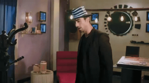 Man in Striped Hat Standing by Piano