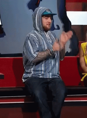 Man in Striped Shirt and Hoodie Clapping