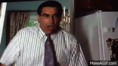 Man in Striped Shirt and Tie in Kitchen