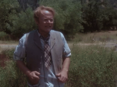 Man in Striped Shirt and Tie Running in Field