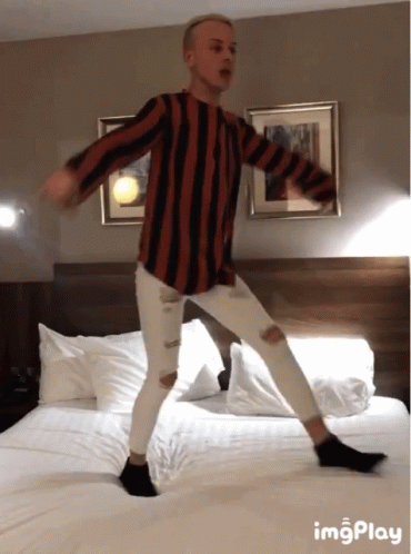 Man in Striped Shirt Dancing on Bed With ImgPlay