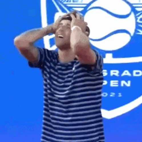 Man in Striped Shirt Holding Head Grad Open