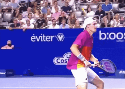 Man in Striped Shirt Holding Tennis Ball