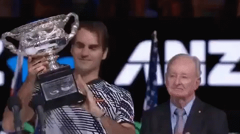 Man In Striped Shirt Holding Trophy GIF