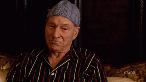 Man In Striped Shirt Holding Whiskey At Starz Sign GIF