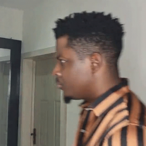 Man in Striped Shirt in Front of Mirror