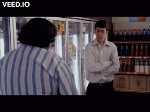 Man in Striped Shirt in Front of Refrigerator Veed.io