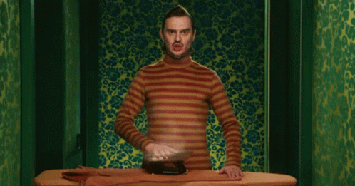 Man in Striped Shirt Ironing