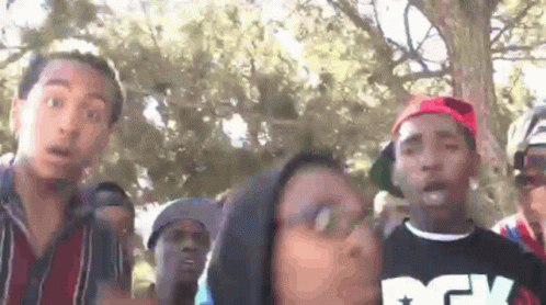 Man In Striped Shirt Looking At Camera GIF