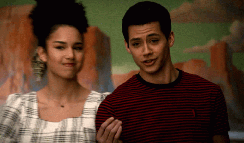 Man In Striped Shirt Next To Woman GIF