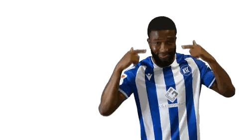Man in Striped Shirt Points to Ears
