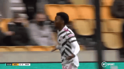 Man in Striped Shirt Running on Soccer Field BT Sport
