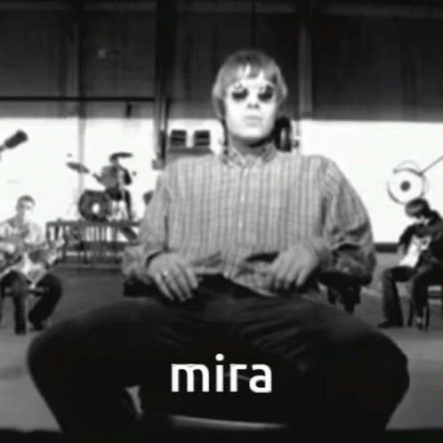 Man in Striped Shirt Sitting on Chair With Word Mira