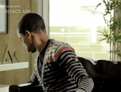 Man in Striped Shirt Sitting on Couch With Reface App