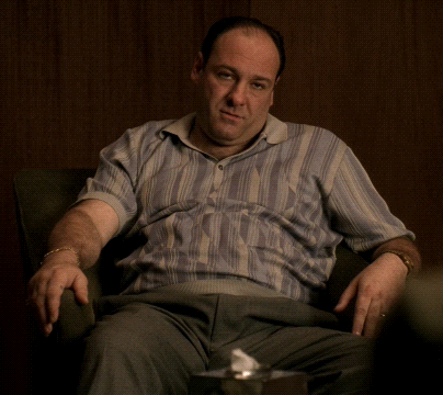 Man In Striped Shirt Sitting GIF