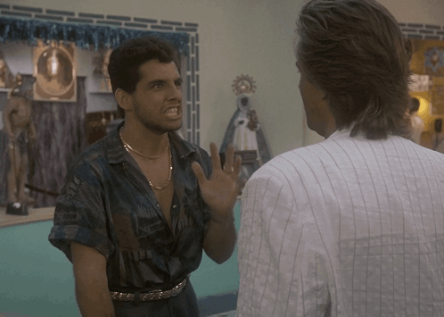 Man In Striped Shirt Talking To Man In Blue Shirt GIF