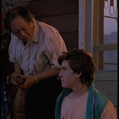 Man in Striped Shirt with Boy in Pink Shirt