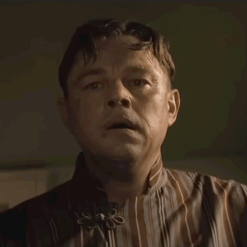 Man In Striped Shirt With Flower Collar GIF
