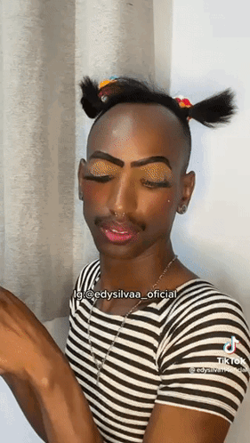 Man in Striped Shirt With Pigtail and Makeup