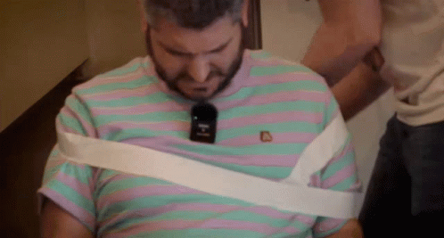 Man In Striped Shirt Wrapped In White Tape GIF